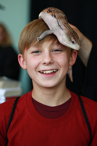 Boy with lizard on his head