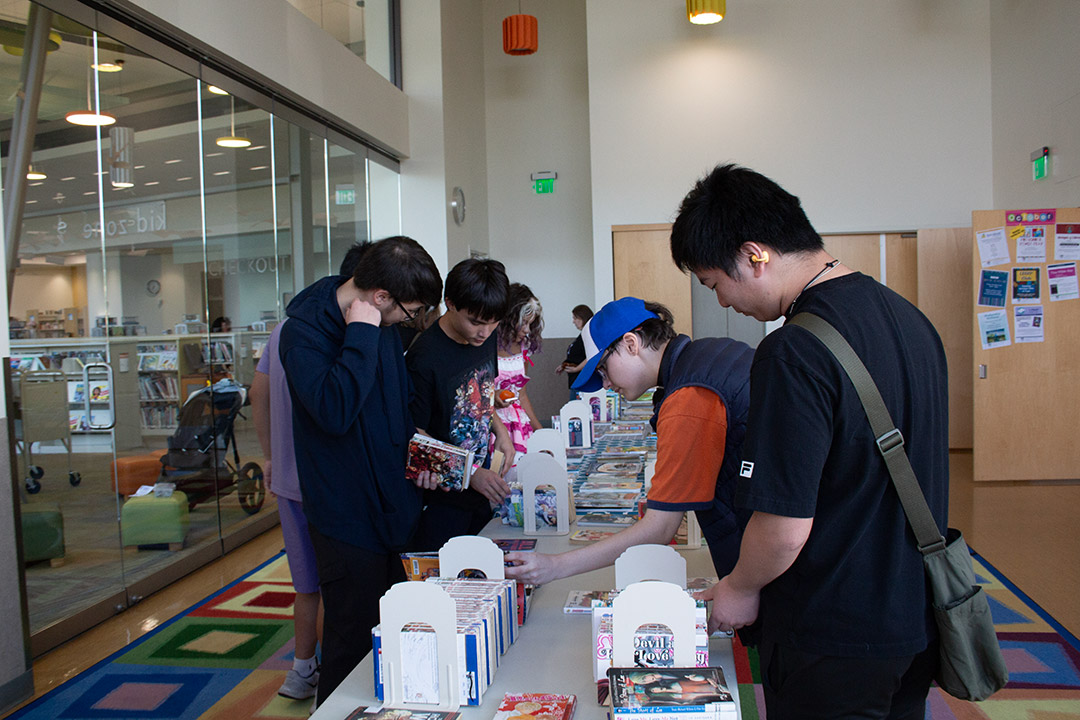 Attendees browse books at a table