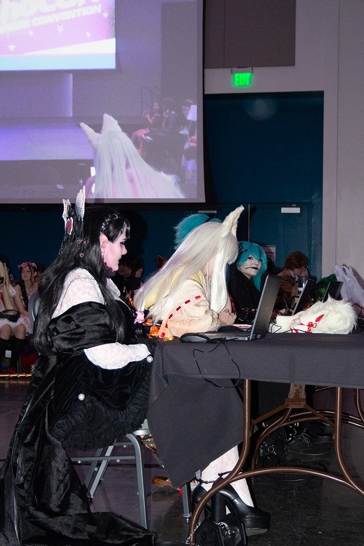 Cosplayers at a table 